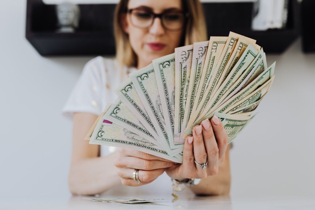 A woman with money on her hands with installment loans opportunities.
