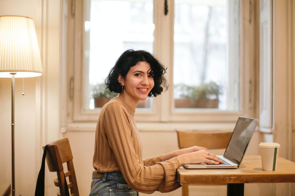 A woman typing in a laptop for getting an installment loan.