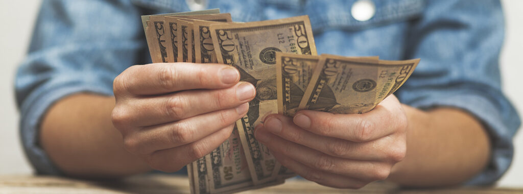 A man with money in his hands for a short-term personal loan