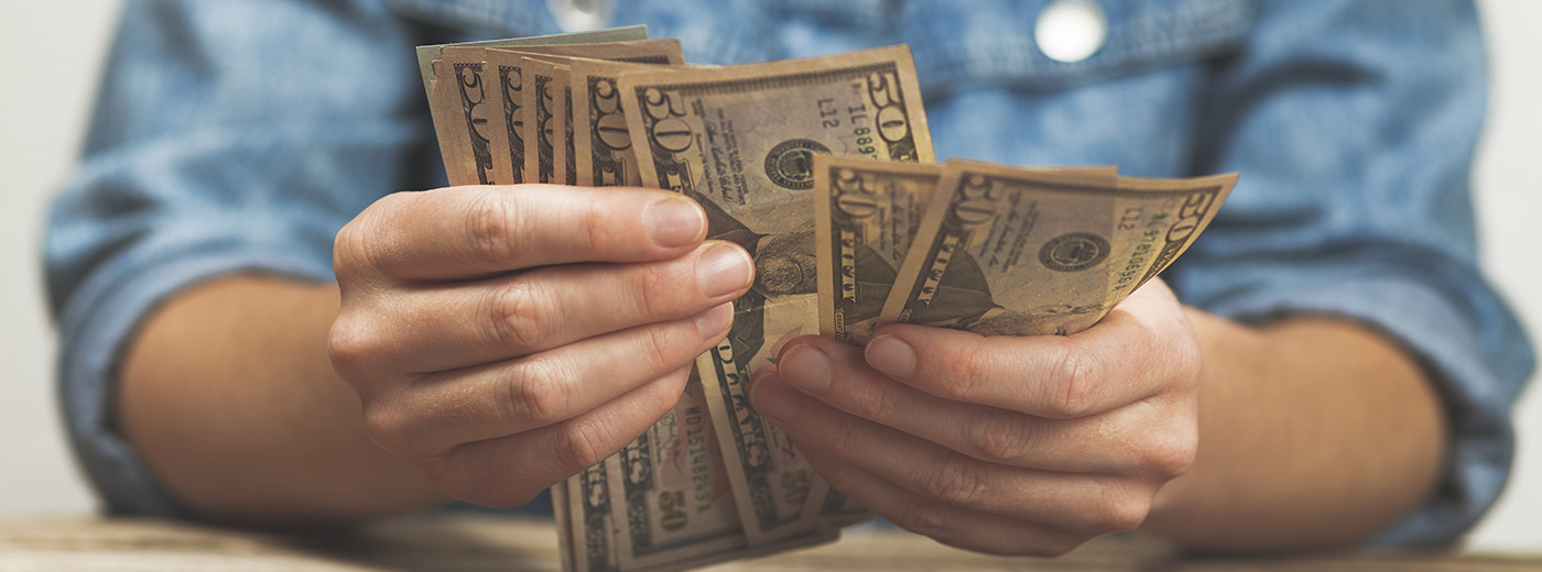 A man is holding money in his hands.
